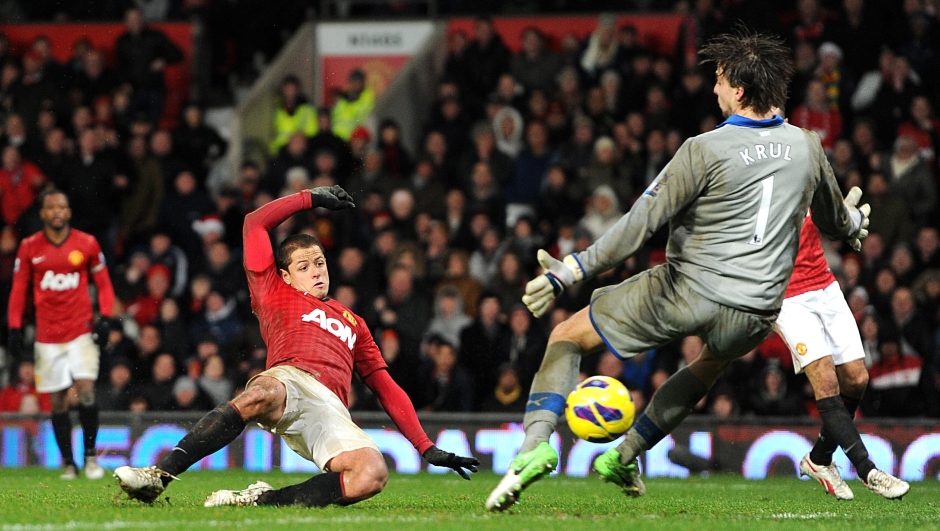 Manchester United's Javier Hernandez scores past Newcastle United's goalkeeper Tim Krul, right, during the English Premier League soccer match at Old Trafford, Manchester, England, Wednesday Dec. 26, 2012. Manchester United won the match 4-3. (AP Photo/PA, Martin Rickett) UNITED KINGDOM OUT NO SALES NO ARCHIVE