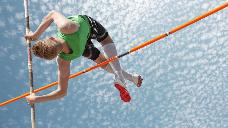 Young athletes pole vault seems to reach the sky