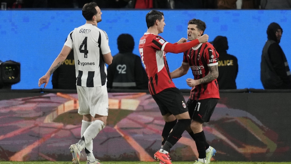 AC Milan's Alvaro Morata, left, and Christian Pulisic celebrate after scoring during the Italian Super Cup semifinal soccer match between Juventus and Milan in Riyadh, Saudi Arabia, Friday, Jan. 3, 2025. (AP Photo/Altaf Qadri)