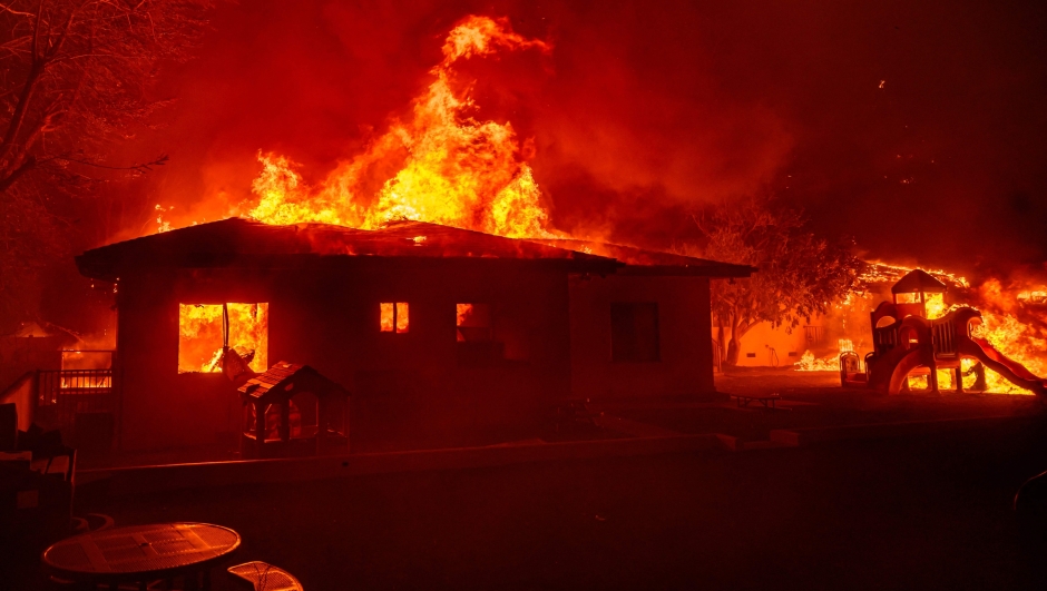 TOPSHOT - A home is engulfed in flames during the Eaton fire in Pasadena, California on January 7, 2025. A ferocious wildfire in a Los Angeles suburb devoured buildings and sparked panicked evacuations January 7, as hurricane-force winds tore through the region. More than 200 acres (80 hectares) was burning in Pacific Palisades, a upscale spot with multi-million dollar homes in the Santa Monica Mountains. Across town, on the northern edge of Los Angeles, another fire broke out in Eaton Canyon, near Pasadena, quickly consuming 200 acres (81 hectares) later in the night, according to Angeles National Forest officials. (Photo by JOSH EDELSON / AFP)