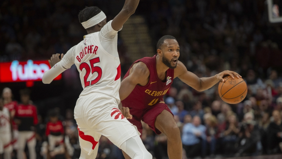 Toronto Raptors' Chris Boucher (25) tries to stop Cleveland Cavaliers' Evan Mobley, right, during the second half of an NBA basketball game in Cleveland, Thursday, Jan. 9, 2025. (AP Photo/Phil Long)