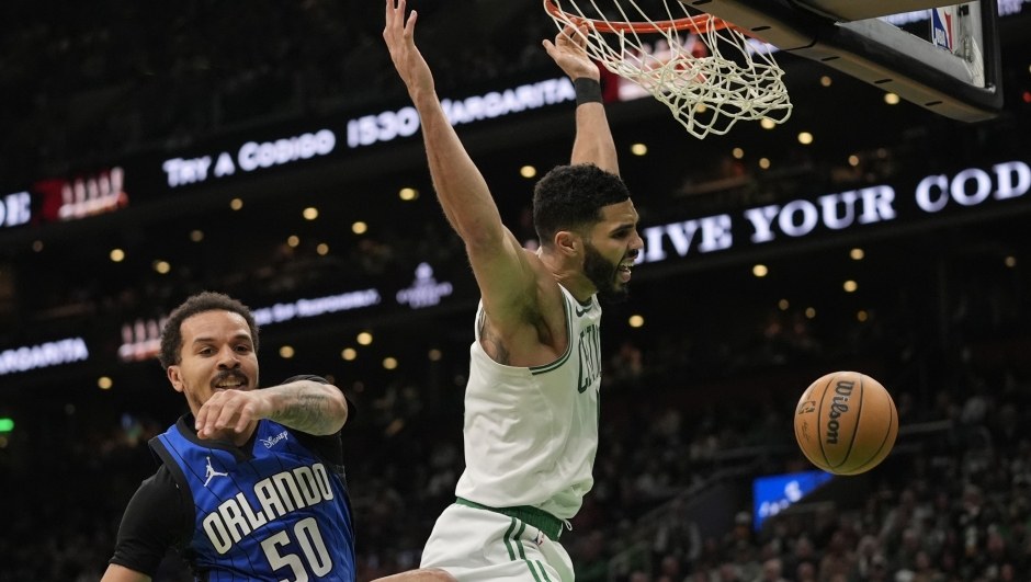 Boston Celtics' Jayson Tatum, right, is fouled on a dunk against Orlando Magic's Cole Anthony (50) during the first half of an NBA basketball game, Friday, Jan. 17, 2025, in Boston. (AP Photo/Robert F. Bukaty)