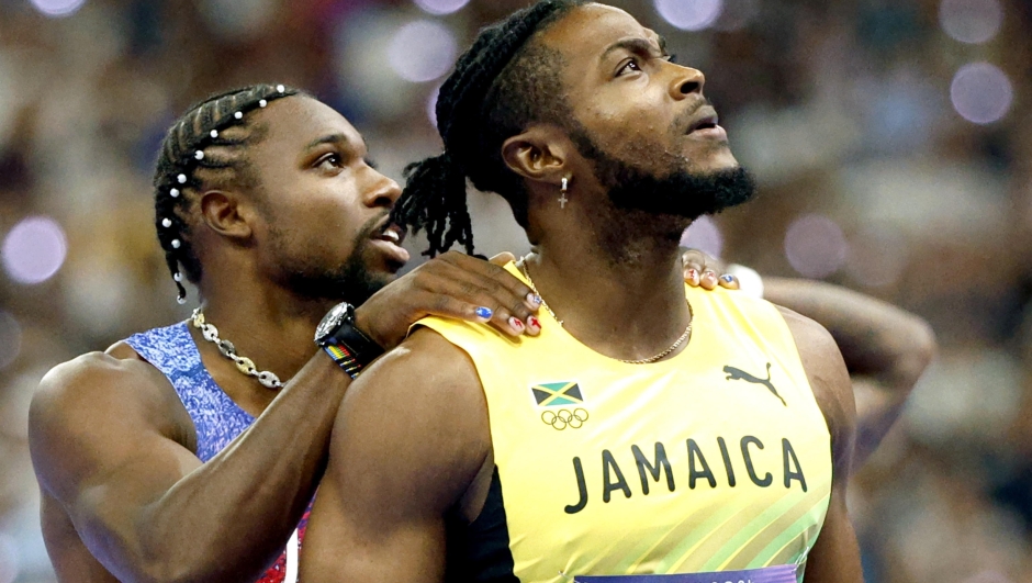 epa11526399 Kishane Thompson (R) of Jamaica and Noah Lyles of the USA look at the results on the stadium screen after the Men 100m final of the Athletics competitions in the Paris 2024 Olympic Games, at the Stade de France stadium in Saint Denis, France, 04 August 2024. Lyles won the race, Thompson placed second.  EPA/FRANCK ROBICHON