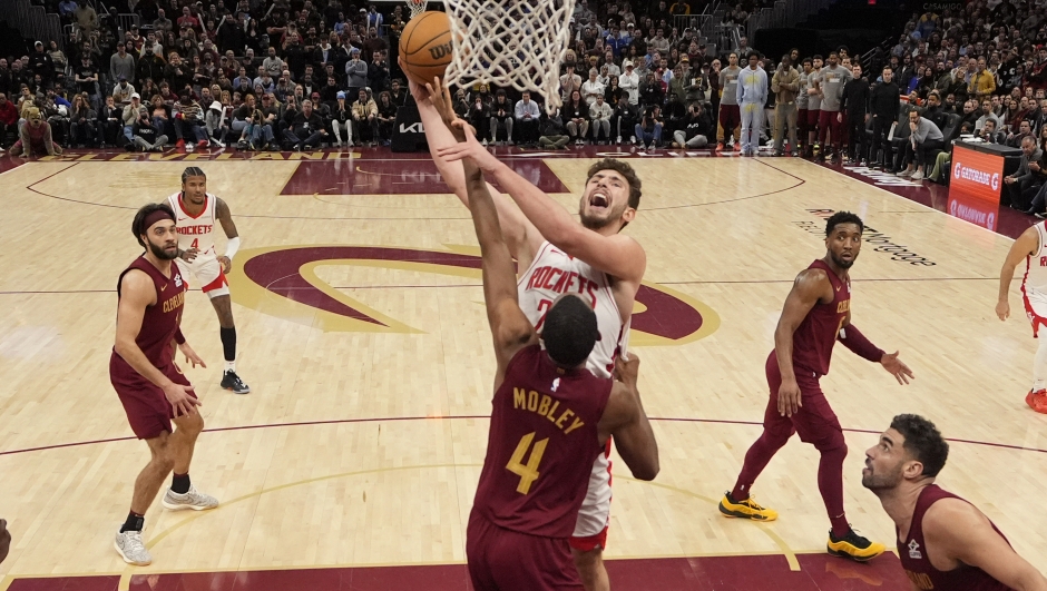 Houston Rockets center Alperen Sengun shoots over Cleveland Cavaliers forward Evan Mobley (4) in the second half of an NBA basketball game, Saturday, Jan. 25, 2025, in Cleveland. (AP Photo/Sue Ogrocki)