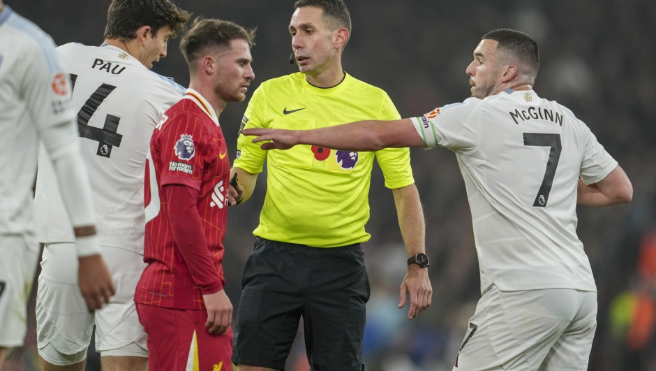 Referee David Coote officiates during the English Premier League soccer match between Liverpool and Aston Villa at the Anfield stadium in Liverpool, Saturday, Nov. 9, 2024. (AP Photo/Jon Super)