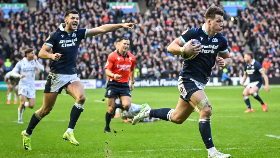 Scotland's centre Huw Jones (R) runs to score a try during the Six Nations international rugby union match between Scotland and Italy at Murrayfield Stadium in Edinburgh, Scotland on February 1, 2025. (Photo by ANDY BUCHANAN / AFP)