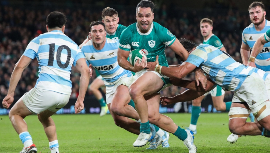 Ireland's wing James Lowe (C) runs with the ball as he is is tackled by Argentina's Ignacio Ruiz (R) during the International rugby union test match between Ireland and Argentina at the Aviva Stadium in Dublin, on November 15, 2024. (Photo by PAUL FAITH / AFP)