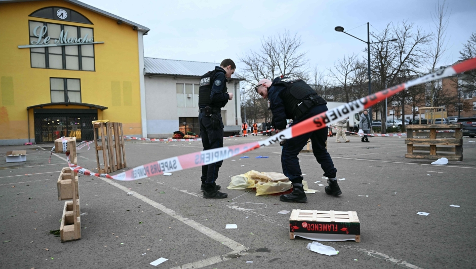 French municpal Police officers work to collect evidence at the site of a bladed weapon attack where a man is suspected of killing one person and wounding two municipal police officers in Mulhouse, eastern France on February 22, 2025. (Photo by SEBASTIEN BOZON / AFP)