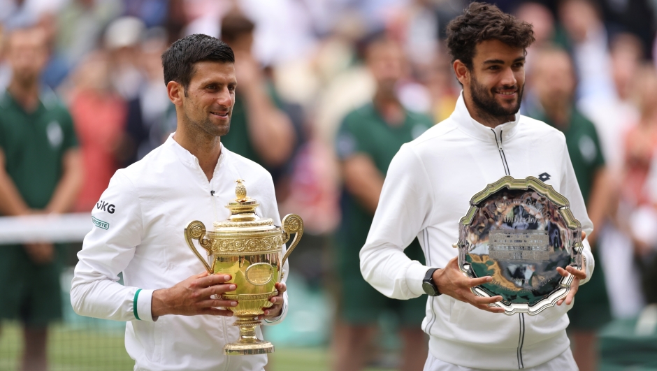  Novak Djokovic of Serbia poses with the winners trophy after winning his men's Singles Final match against Matteo Berrettini of Italy who poses with the runners up trophy on Day Thirteen of The Championships - Wimbledon 2021 at All England Lawn Tennis and Croquet Club on July 11, 2021 in London, England. (Photo by Steven Paston - Pool/Getty Images)