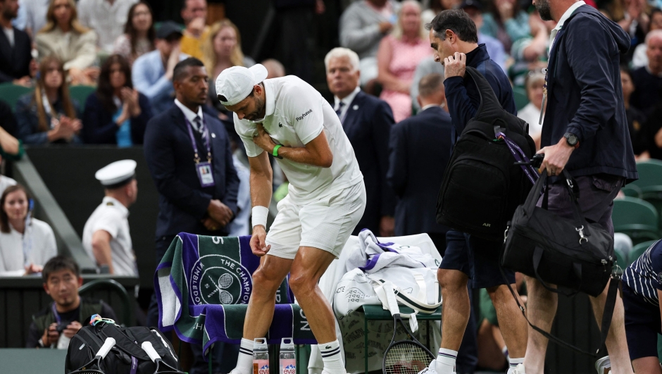 Bulgaria's Grigor Dimitrov reacts after getting injured as he plays against Italy's Jannik Sinner during their men's singles fourth round tennis match on the eighth day of the 2025 Wimbledon Championships at The All England Lawn Tennis and Croquet Club in Wimbledon, southwest London, on July 7, 2025. (Photo by Adrian Dennis / AFP) / RESTRICTED TO EDITORIAL USE