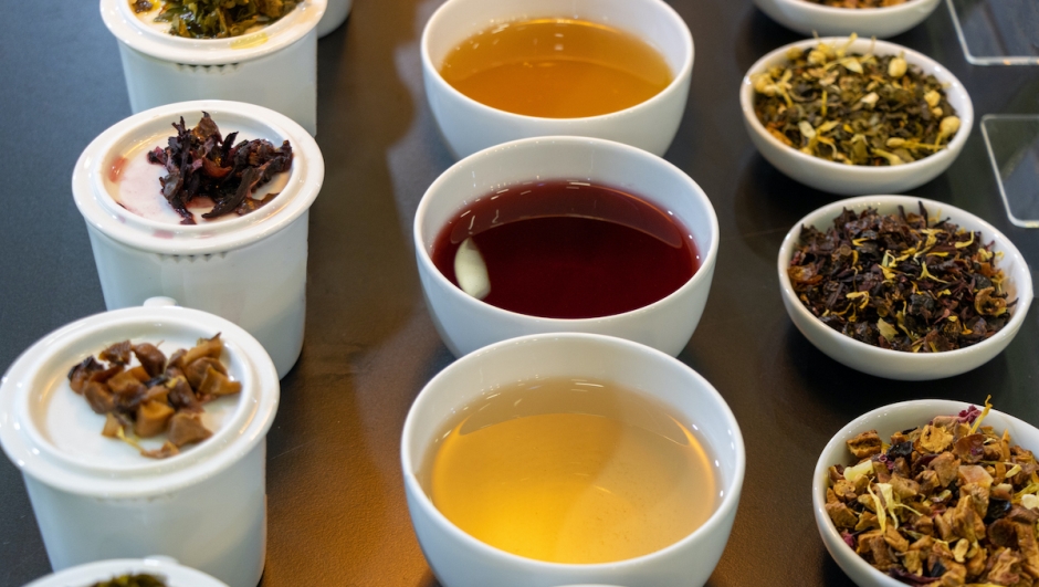 Various herbal teas in porcelain cups and bowls