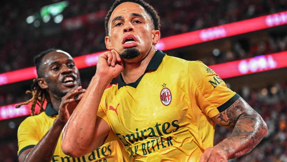 AC Milan's Noah Okafor (R) celebrates with teammate Warren Bondo after scoring a goal in their friendly exhibition football match against Liverpool at the Kai Tak Stadium in Hong Kong on July 26, 2025. (Photo by Peter PARKS / AFP)