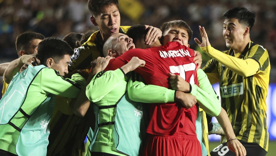 Players embrace Kairat's goalkeeper Temirlan Anarbekov after winning the Champions League playoff second leg soccer match between Kairat and Celtic at Ortalyk stadium in Almaty, Kazakhstan, Wednesday, Aug. 27, 2025. (AP Photo/Alikhan Sariyev)