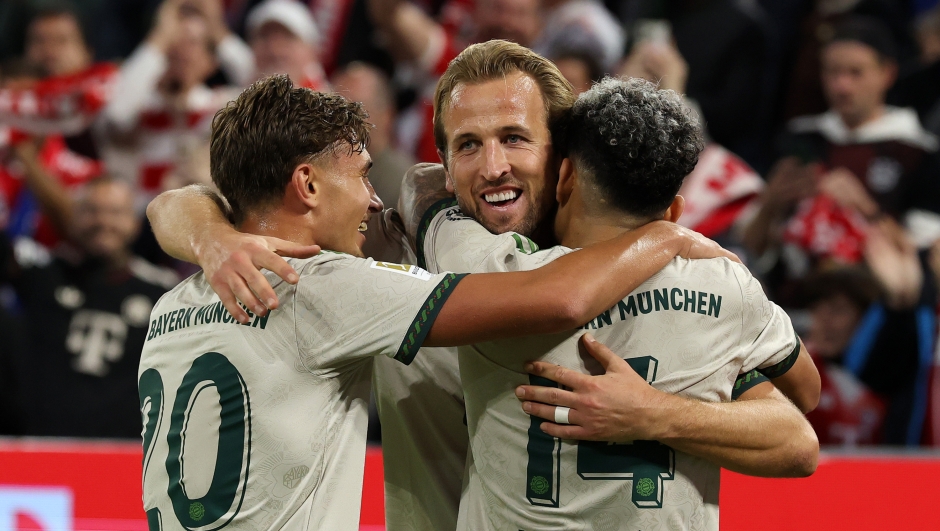 Harry Kane of Bayern Munich celebrates with teammates Tom Bischof and Luis Diaz after scoring his team's third goal to reach a record 100 club goals during the Bundesliga match between FC Bayern München and SV Werder Bremen at Allianz Arena on September 26, 2025 in Munich, Germany. (Photo by Alexander Hassenstein/Getty Images)