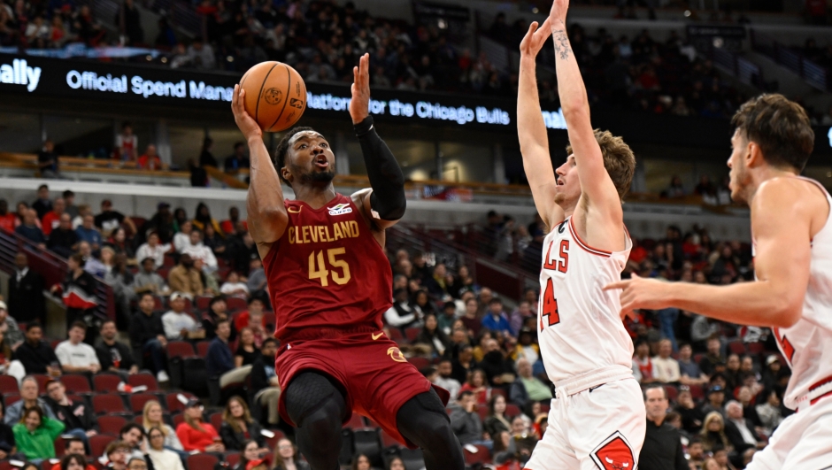 Cleveland Cavaliers' Donovan Mitchell (45) goes up to shoot against Chicago Bulls' Matas Buzelis (14) during the second half of an NBA basketball preseason game in Chicago, Thursday, Oct. 9, 2025. (AP Photo/Paul Beaty)