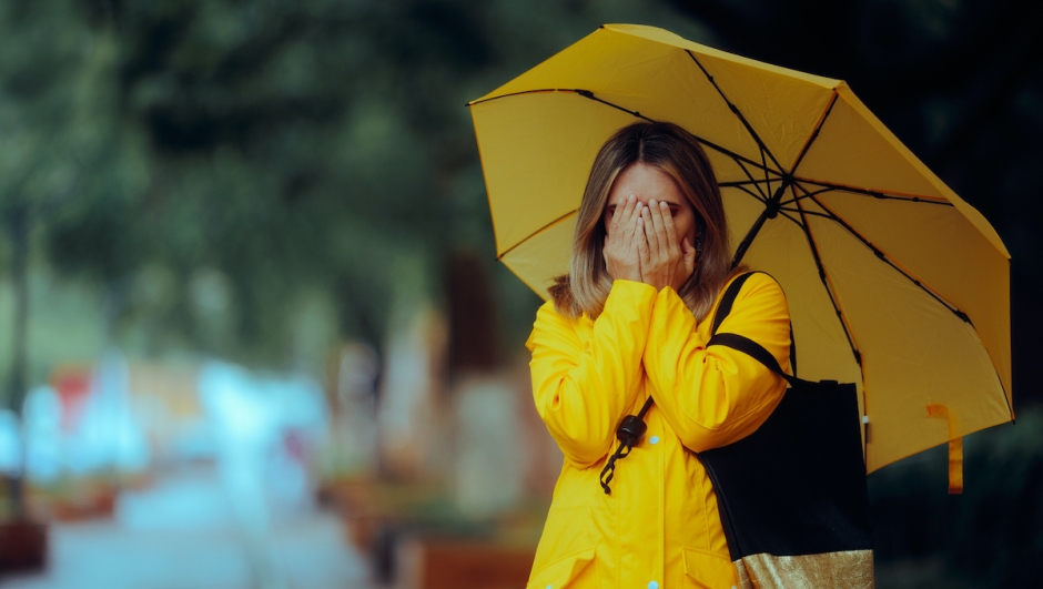 Sad unhappy girl covering her face suffering from seasonal affective disorder