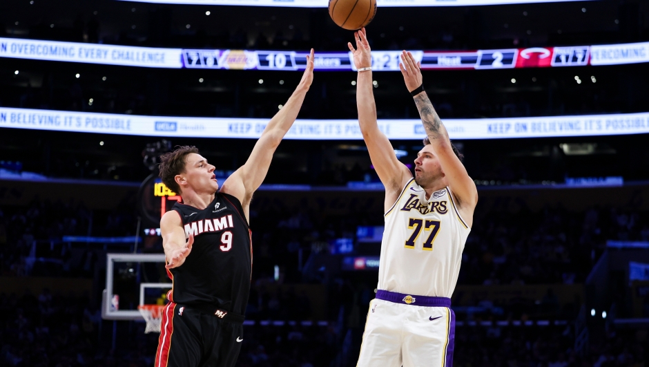 Los Angeles Lakers guard Luka Doncic (77) shoots against Miami Heat guard Pelle Larsson (9) during the first half of an NBA basketball game, Sunday, Nov. 2, 2025, in Los Angeles. (AP Photo/Jessie Alcheh)