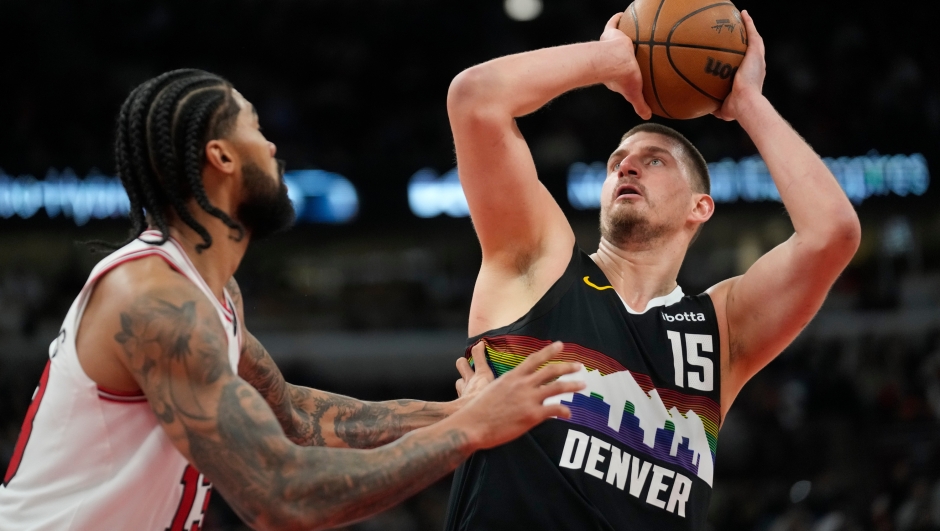 Denver Nuggets center Nikola Jokic (15), right, handles the ball as Chicago Bulls center Nick Richards (13) defends during the second half of an NBA basketball game Saturday, Feb. 7, 2026, in Chicago. (AP Photo/Erin Hooley)