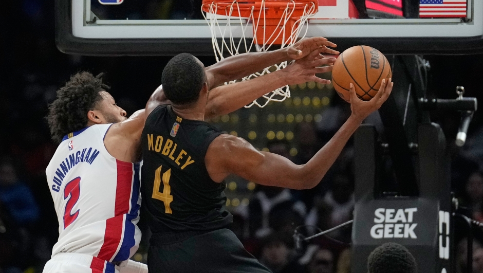 Detroit Pistons guard Cade Cunningham (2) fouls Cleveland Cavaliers center Evan Mobley (4) in the second half of an NBA basketball game in Cleveland, Tuesday, March 3, 2026. (AP Photo/Sue Ogrocki)