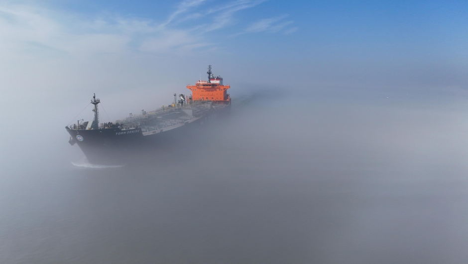 epa12794243 A drone image shows an aerial view of oil tanker Torm Denise (IMO 9702211) registered in Singapore in the fog as she approach Antwerp Chemical harbour, near Hansweert, the Netherlands, 04 March 2026. The EU Commission is to present EU Industrial Maritime and Port Strategies, following the closure of the Strait of Hormuz amid the escalating regional conflict leading to growing concern over global oil supplies.  EPA/OLIVIER HOSLET