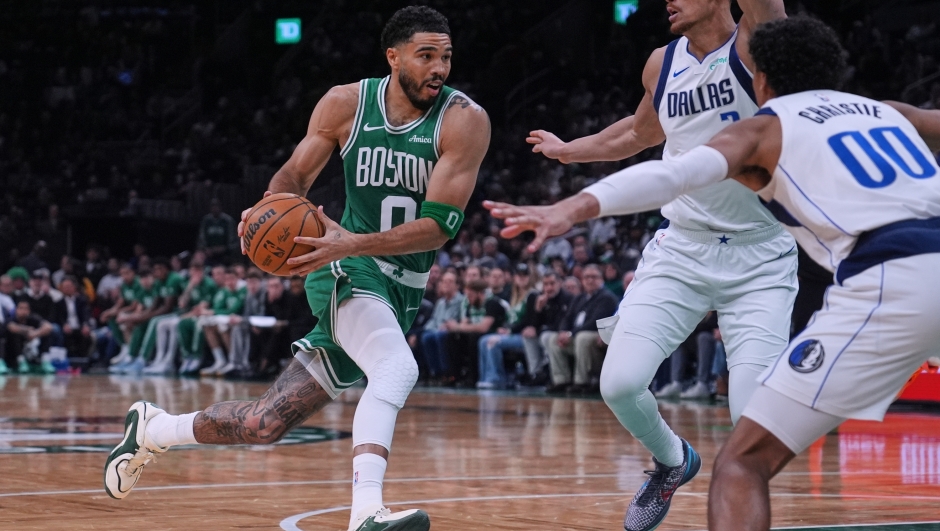 Boston Celtics forward Jayson Tatum (0) paases by Dallas Mavericks guard Max Christie (00) during the second half of an NBA basketball game, Friday, March 6, 2026, in Boston. (AP Photo/Charles Krupa)