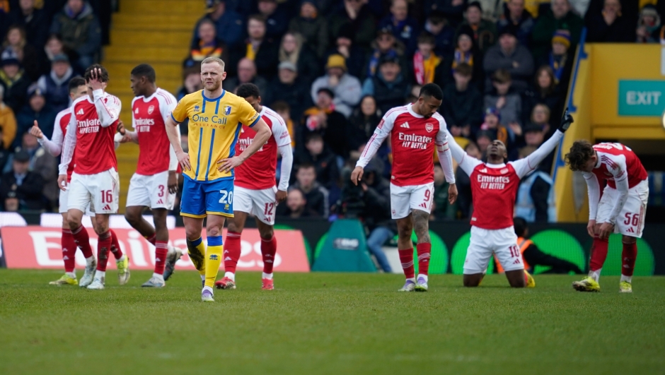 Mansfield's Frazer Blake-Tracy is dejected after Arsenal's Eberechi Eze, second from right, scored his side's second goal during the English FA Cup soccer match between Mansfield Town and Arsenal in Mansfield, England, Saturday, March 7, 2026.(AP Photo/Dave Thompson)