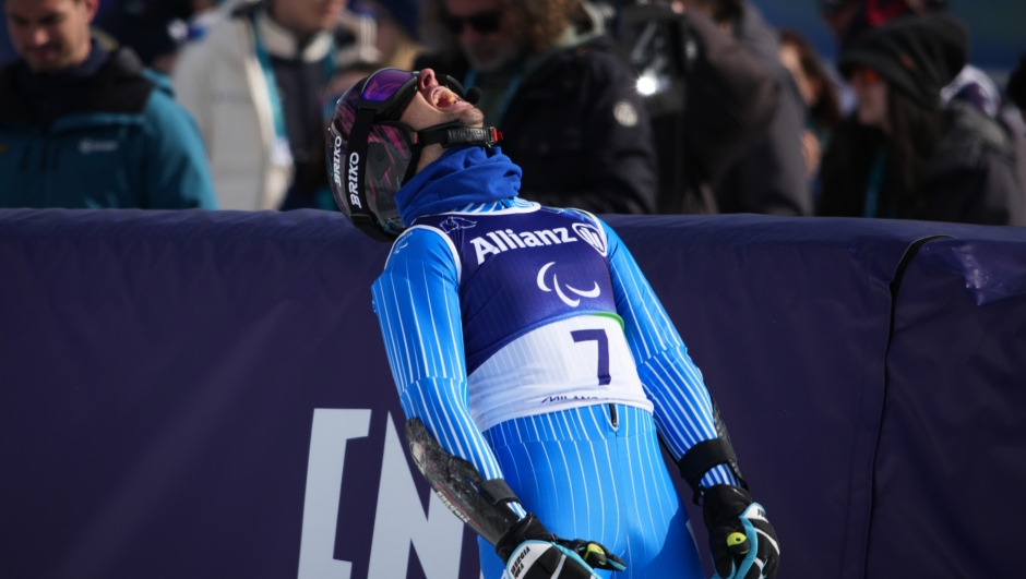 Giacomo Bertagnolli, of Italy, reacts after crossing the finish line in the alpine skiing men's super-G VI final at the 2026 Winter Paralympics, in Cortina d'Ampezzo, Italy, Monday, March 9, 2026. (AP Photo/Emilio Morenatti)