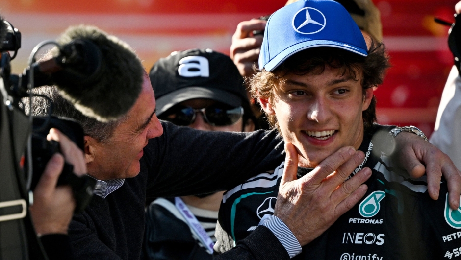 TOPSHOT - Mercedes' Italian driver Kimi Antonelli (R) celebrates winning the pole position with his father Marco Antonelli after the qualifying session ahead of the Formula One Chinese Grand Prix at the Shanghai International Circuit in Shanghai on March 14, 2026. (Photo by GREG BAKER / AFP)