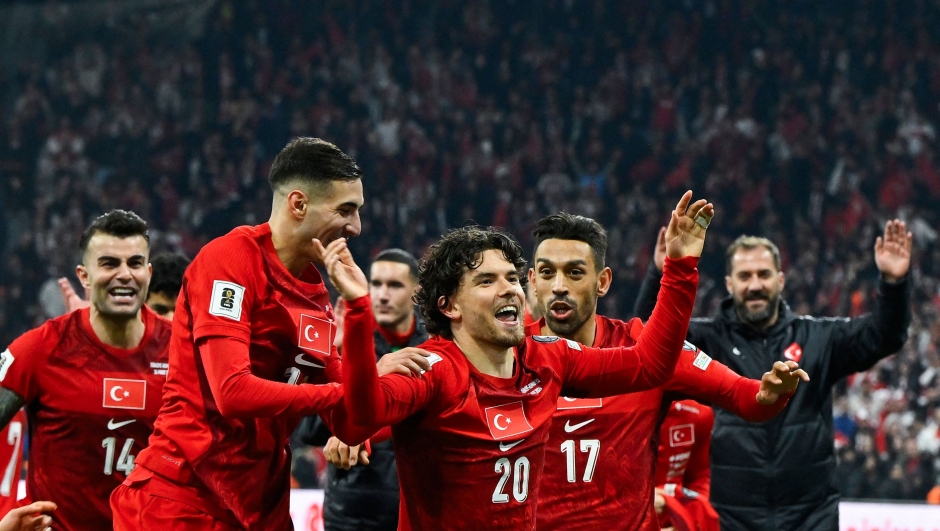 Turkey's defender #20 Ferdi Kadioglu (C) celerbates with his teammates after winning the play-off FIFA World Cup 2026 European qualification knockout semi-final football match between Turkey and Romania at Besiktas Park stadium, in Istanbul on March 26, 2026. (Photo by YASIN AKGUL / AFP)