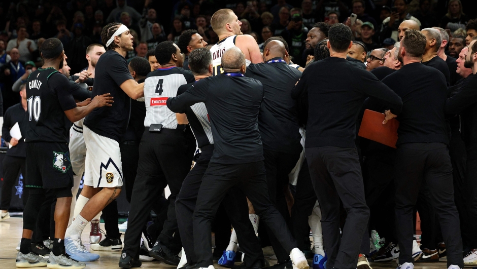  Members of the Denver Nuggets and Minnesota Timberwolves get into a scrum in the fourth quarter of Game Four of the First Round of the 2026 NBA Western Conference Playoffs at Target Center on April 25, 2026 in Minneapolis, Minnesota. Nikola Jokic #15 of the Denver Nuggets and Julius Randle #30 of the Minnesota Timberwolves were ejected from the game. The Timberwolves defeated the Nuggets 112-96. NOTE TO USER: User expressly acknowledges and agrees that, by downloading and or using this photograph, User is consenting to the terms and conditions of the Getty Images License Agreement.   David Berding/Getty Images/AFP (Photo by David Berding / GETTY IMAGES NORTH AMERICA / Getty Images via AFP)