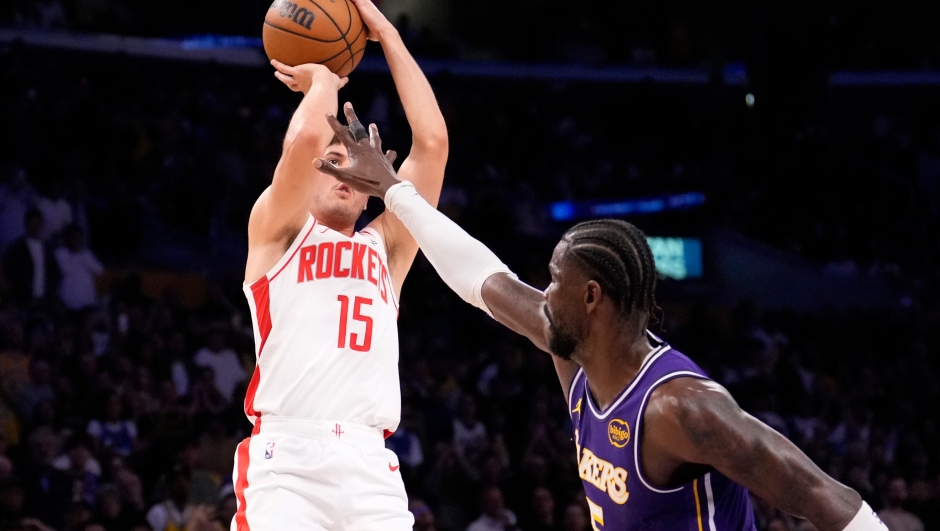 Houston Rockets guard Reed Sheppard, left, shoots as Los Angeles Lakers center Deandre Ayton defends during the second half in Game 5 of a first-round NBA playoffs basketball series Wednesday, April 29, 2026, in Los Angeles. (AP Photo/Mark J. Terrill)