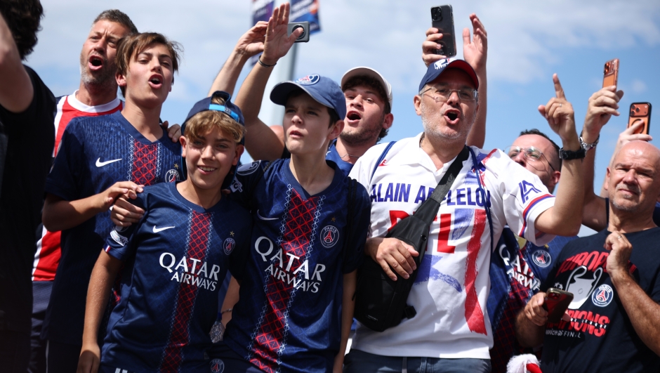 PSG supporters react as they make their way to the stadium ahead of the Champions League final soccer match between Paris Saint-Germain and Arsenal in Budapest, Hungary, Saturday, May 30, 2026. (AP Photo/Rudolf Karancsi-Albert)