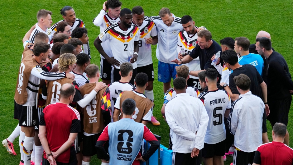 Germany manager Julian Nagelsmann, right, speaks with his team during a hydration break during the World Cup Group E soccer match between Germany and Ivory Coast in Toronto, Saturday, June 20, 2026. (Chris Young/The Canadian Press via AP)