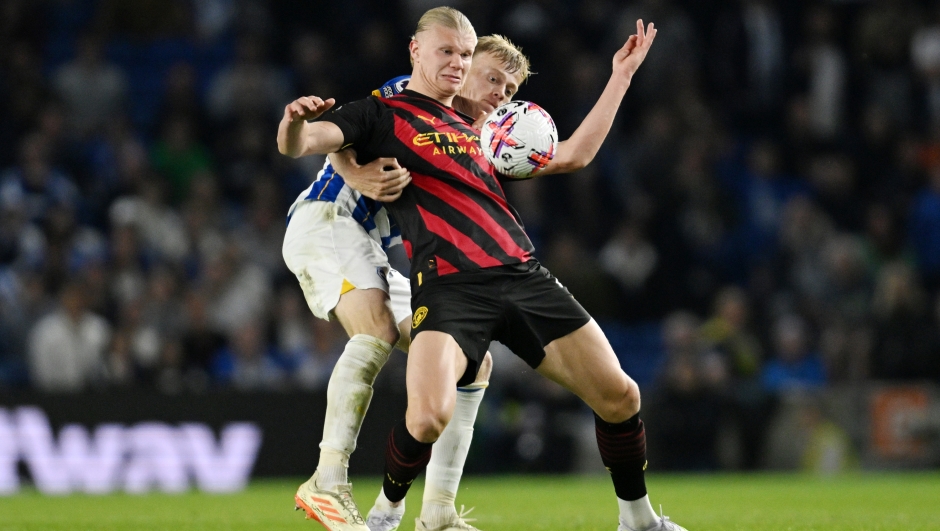  Erling Haaland of Manchester City battles for possession with Jan Paul van Hecke of Brighton & Hove Albion during the Premier League match between Brighton & Hove Albion and Manchester City at American Express Community Stadium on May 24, 2023 in Brighton, England. (Photo by Mike Hewitt/Getty Images)