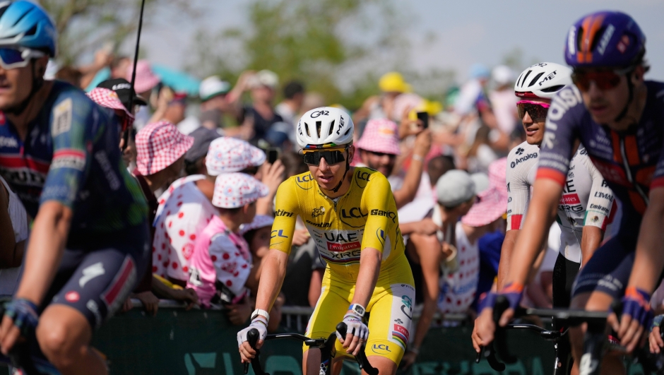 Slovenia's Tadej Pogacar, wearing the overall leader's yellow jersey, crosses the finish of the eleventh stage of the Tour de France cycling race with start in Vichy and finish in Nevers, France, Wednesday, July 15, 2026. (AP Photo/Mosa'ab Elshamy)