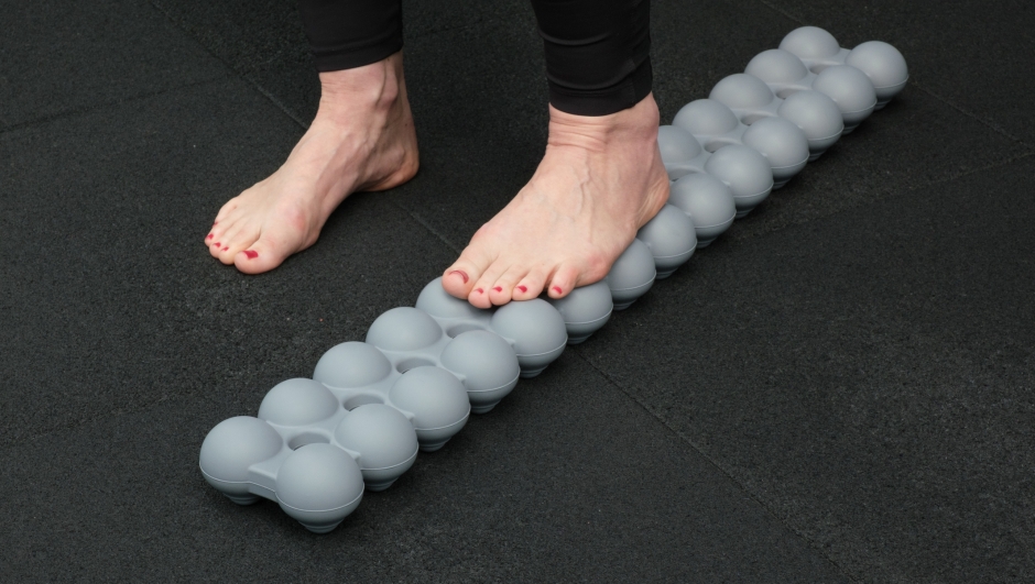 Close-up of the patient's legs walking on carpet in a rehabilitation room.