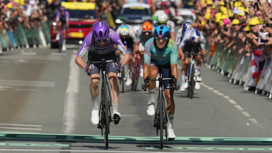 Switzerland's Mauro Schmid, left, crosses the finish line ahead of Colombia's Harold Tejada, right, to win the thirteenth stage of the Tour de France cycling race with start in Dole and finish in Belfort, France, Friday, July 17, 2026. (AP Photo/Thibault Camus)