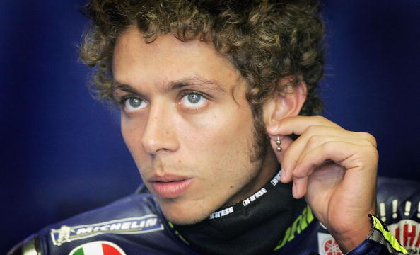 DONINGTON, ENGLAND - JULY 22:  Valentino Rossi of Italy and Yamaha fiddles with his earring in the garage during first free practice for the British Moto GP at Donington Park on July 22, 2005, in Donington, England. (Photo by Clive Mason/Getty Images)