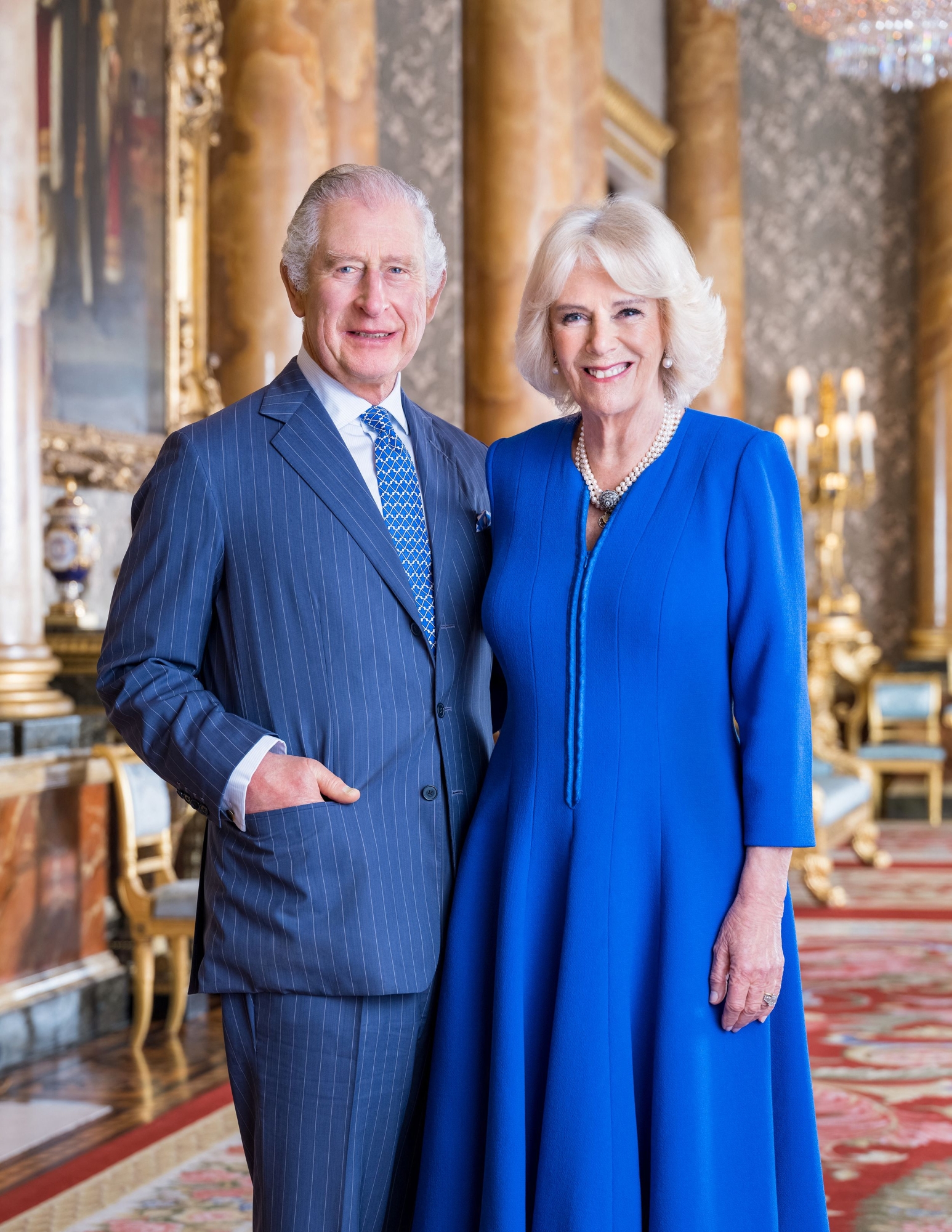 A handout photo taken on March 2023 and issued by Buckingham Palace on April 4, 2023 shows Britain's King Charles III and Britain's Camilla, Queen Consort posing in the Blue Drawing Room at Buckingham Palace, in London. - The portrait has been released to mark their Coronation on May 6, 2023. (Photo by Hugo BURNAND / BUCKINGHAM PALACE / AFP) / RESTRICTED TO EDITORIAL USE - MANDATORY CREDIT "AFP PHOTO / BUCKINGHAM PALACE / HUGO BURNAND " - NO MARKETING NO ADVERTISING CAMPAIGNS - DISTRIBUTED AS A SERVICE TO CLIENTS  This photograph can not be used after 0001 Tuesday May 9, 2023, without prior, written permission from Royal Communications. After that date, no further licensing can be made. Any questions relating to the use of the photographs should be first referred to Buckingham Palace before publication. The portrait should be used in the context of Their Majesties' Coronation.  The photograph is provided to you strictly on condition that you will make no charge for the supply, release or publication of it and that these conditions and restrictions will apply (and that you will pass these on) to any organisation to whom you supply it. There shall be no commercial use whatsoever of the photograph (including by way of example) any use in merchandising, advertising or any other non-news editorial use. The photograph must not be digitally enhanced, manipulated or modified in any manner or form. /