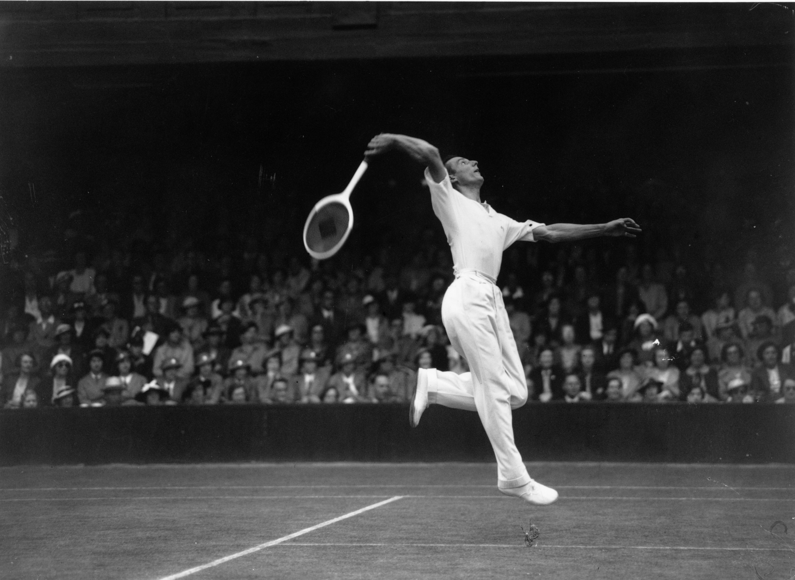 29th June 1936:  British tennis player, Fred Perry in action against BH Grant in court number one at Wimbledon.  (Photo by Hudson/Topical Press Agency/Getty Images)