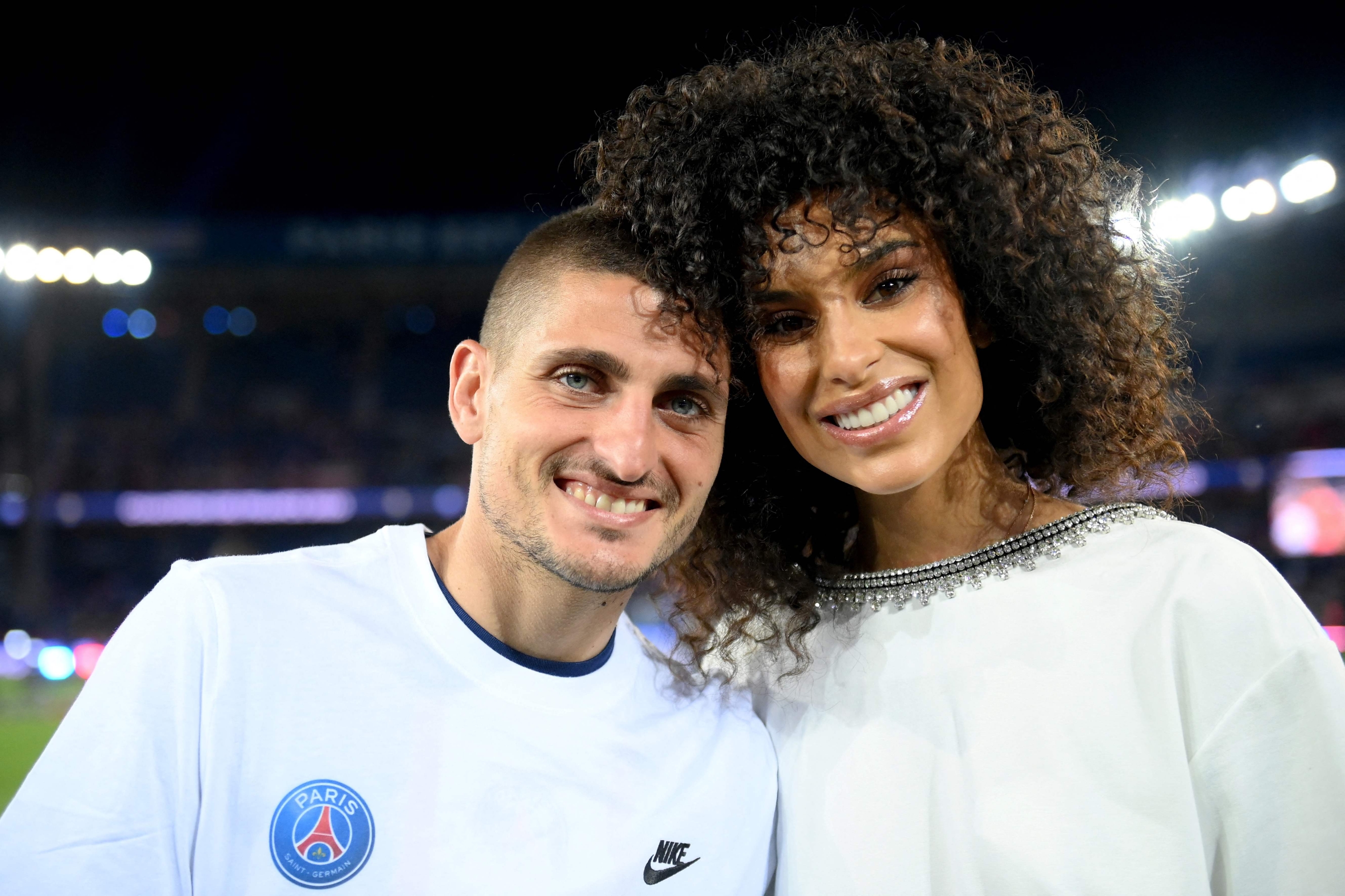 Paris Saint-Germain's Italian midfielder Marco Verratti poses with his wife Jessica Aidi Veratti during the 2022-2023 Ligue 1 championship trophy ceremony following the L1 football match between Paris Saint-Germain (PSG) and Clermont Foot 63 at the Parc des Princes Stadium in Paris on June 3, 2023. (Photo by FRANCK FIFE / POOL / AFP)