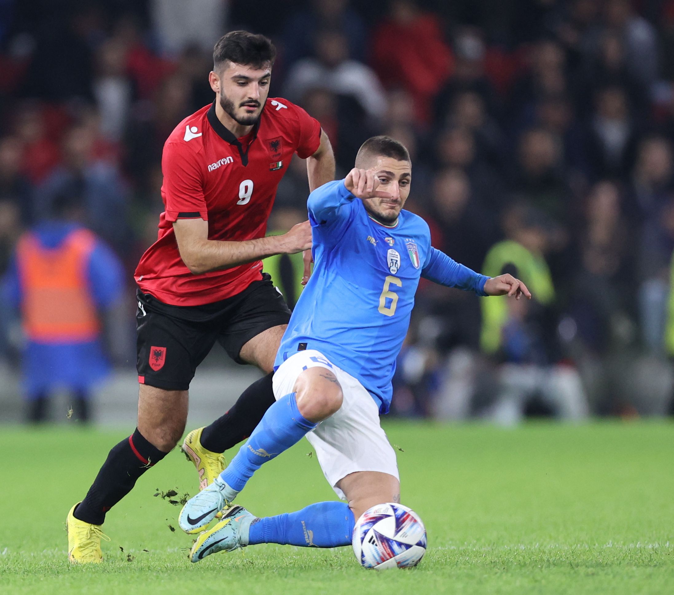 Albania's forward Armando Broja (L) fights for the ball with Italy's midfielder Marco Verratti (R) during a friendly football match between Albania and Italy, at the Air Albania Stadium in Tirana on November 16, 2022. (Photo by Gent SHKULLAKU / AFP)