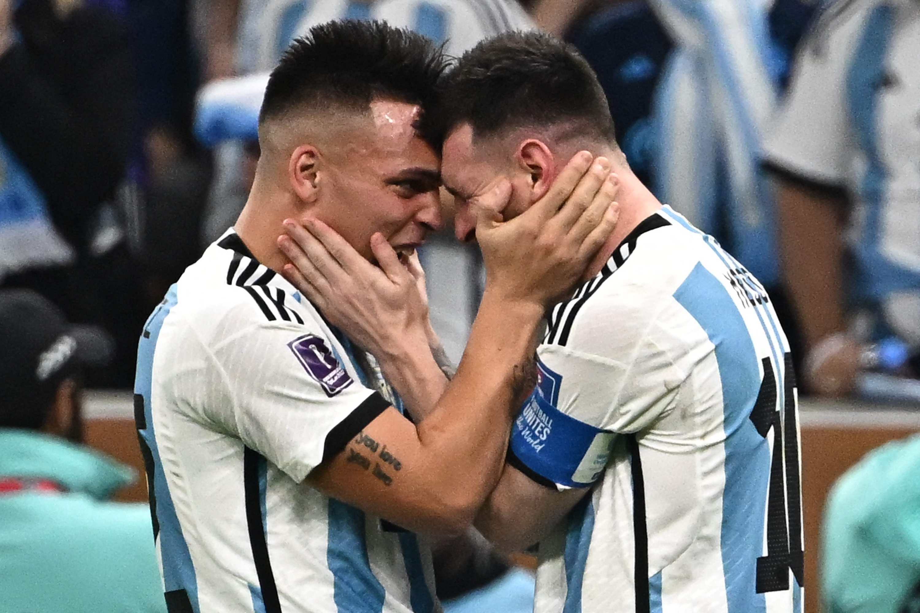 Argentina's forward #22 Lautaro Martinez (L) and Argentina's forward #10 Lionel Messi (R) celebrate after Argentina won the Qatar 2022 World Cup final football match between Argentina and France at Lusail Stadium in Lusail, north of Doha on December 18, 2022. (Photo by Anne-Christine POUJOULAT / AFP)