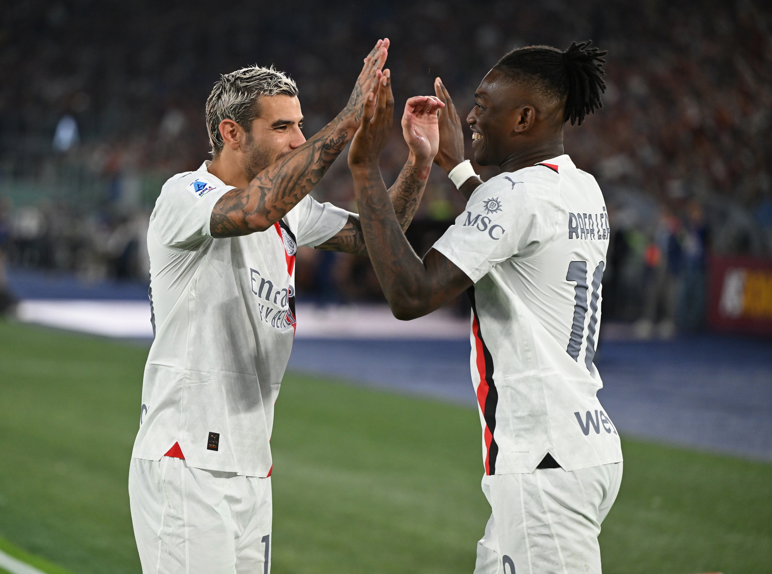 ROME, ITALY - SEPTEMBER 01:  Rafael Leao of AC Milan celebrates with Theo Hernandez after scoring the goal during the Serie A TIM match between AS Roma and AC Milan at Stadio Olimpico on September 01, 2023 in Rome, Italy. (Photo by Claudio Villa/AC Milan via Getty Images)