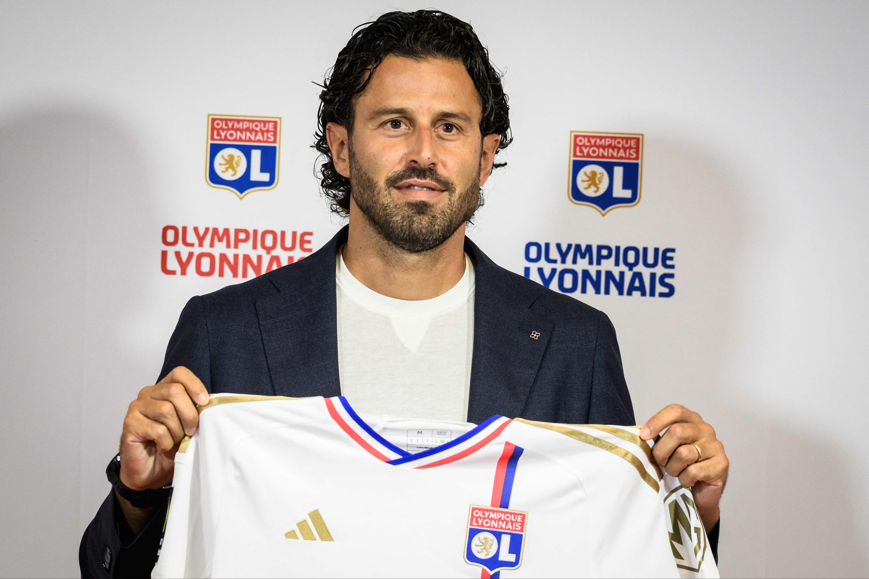 Lyons Italian new head coach Fabio Grosso poses with a team jersey at the end of a press conference in the Decines-Charpieu Groupama Stadium in Decines-Charpieu, central eastern France, on September 18, 2023. Grosso returns to Lyon where he played as a left-back for two years, winning the Ligue 1 and French Cup double in 2008. (Photo by JEFF PACHOUD / AFP)