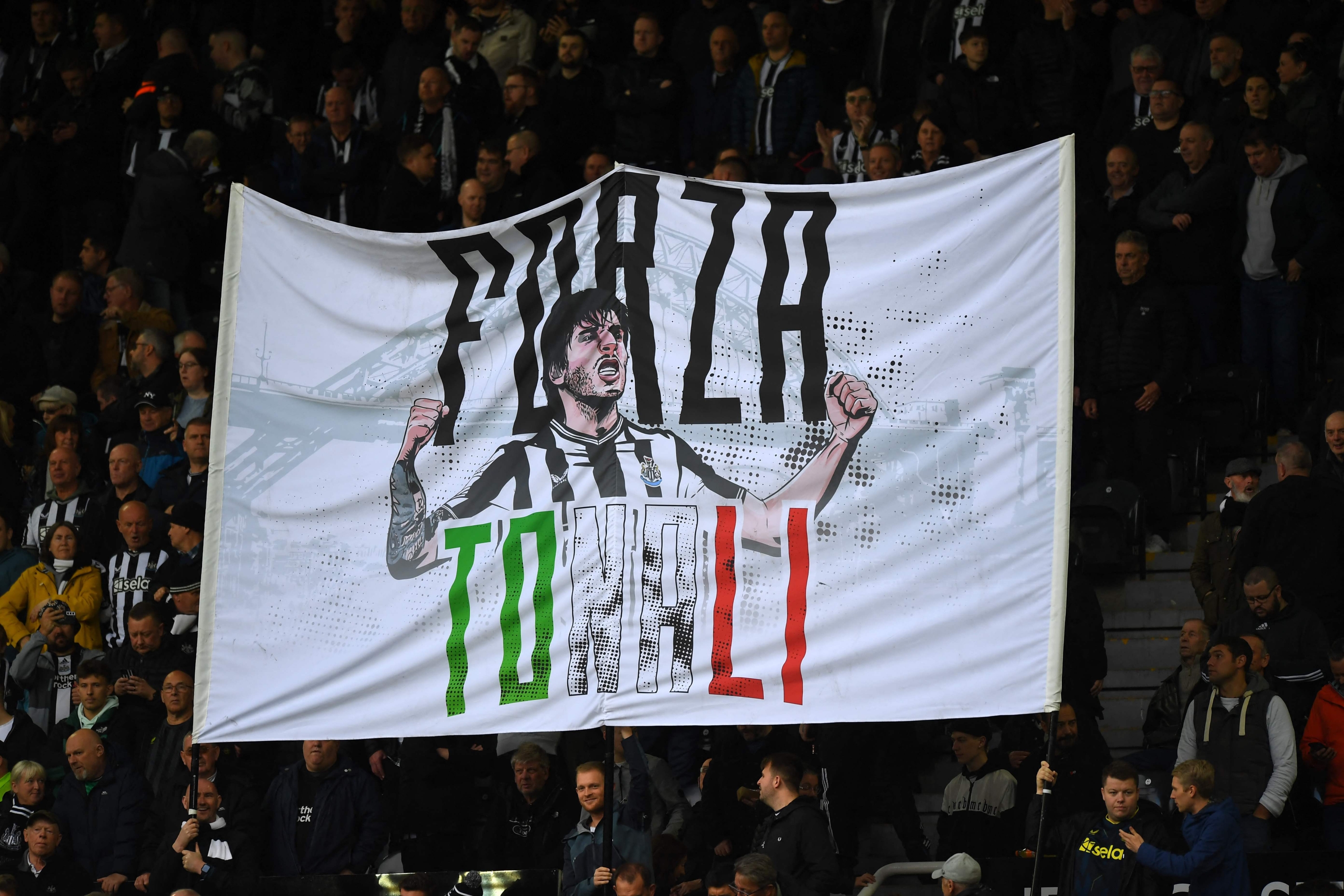 Newcastle fans display a banner in support of Newcastle United's Italian midfielder #08 Sandro Tonali ahead of the English Premier League football match between Newcastle United and Crystal Palace at St James' Park in Newcastle-upon-Tyne, north east England on October 21, 2023. (Photo by ANDY BUCHANAN / AFP) / RESTRICTED TO EDITORIAL USE. No use with unauthorized audio, video, data, fixture lists, club/league logos or 'live' services. Online in-match use limited to 120 images. An additional 40 images may be used in extra time. No video emulation. Social media in-match use limited to 120 images. An additional 40 images may be used in extra time. No use in betting publications, games or single club/league/player publications. /