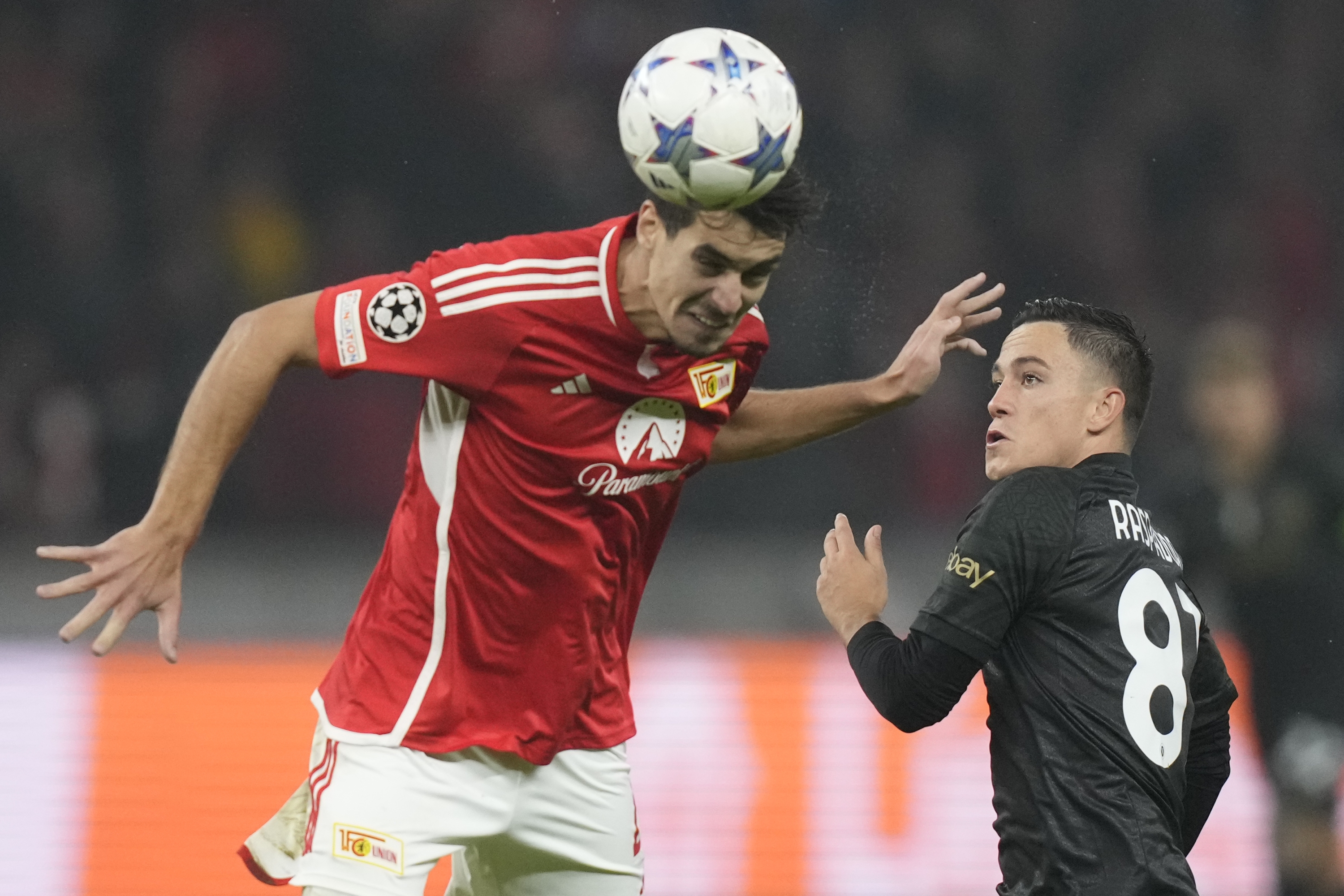 Union's Diogo Leite, left, is challenged by Napoli's Giacomo Raspadori during the group C Champions League soccer match between Union Berlin and Napoli, at the Olympiastadion in Berlin, Germany, Tuesday, Oct. 24, 2023. (AP Photo/Matthias Schrader)