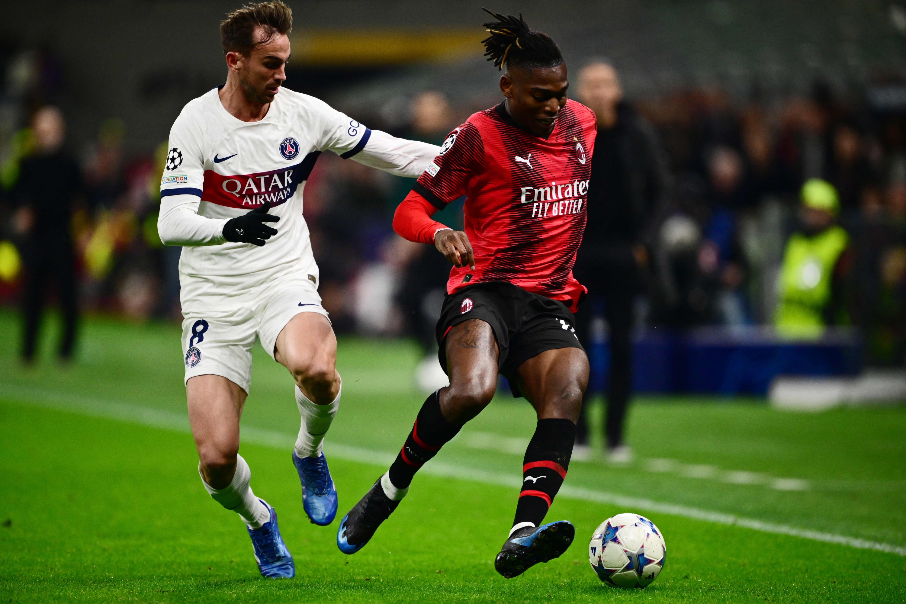 Paris Saint-Germain's Spanish midfielder #08 Fabian Ruiz fights for the ball with AC Milan's Portuguese forward #10 Rafael Leao during the UEFA Champions League 1st round group F football match between AC Milan and Paris Saint-Germain at the San Siro stadium in Milan on November 7, 2023. (Photo by Marco BERTORELLO / AFP)