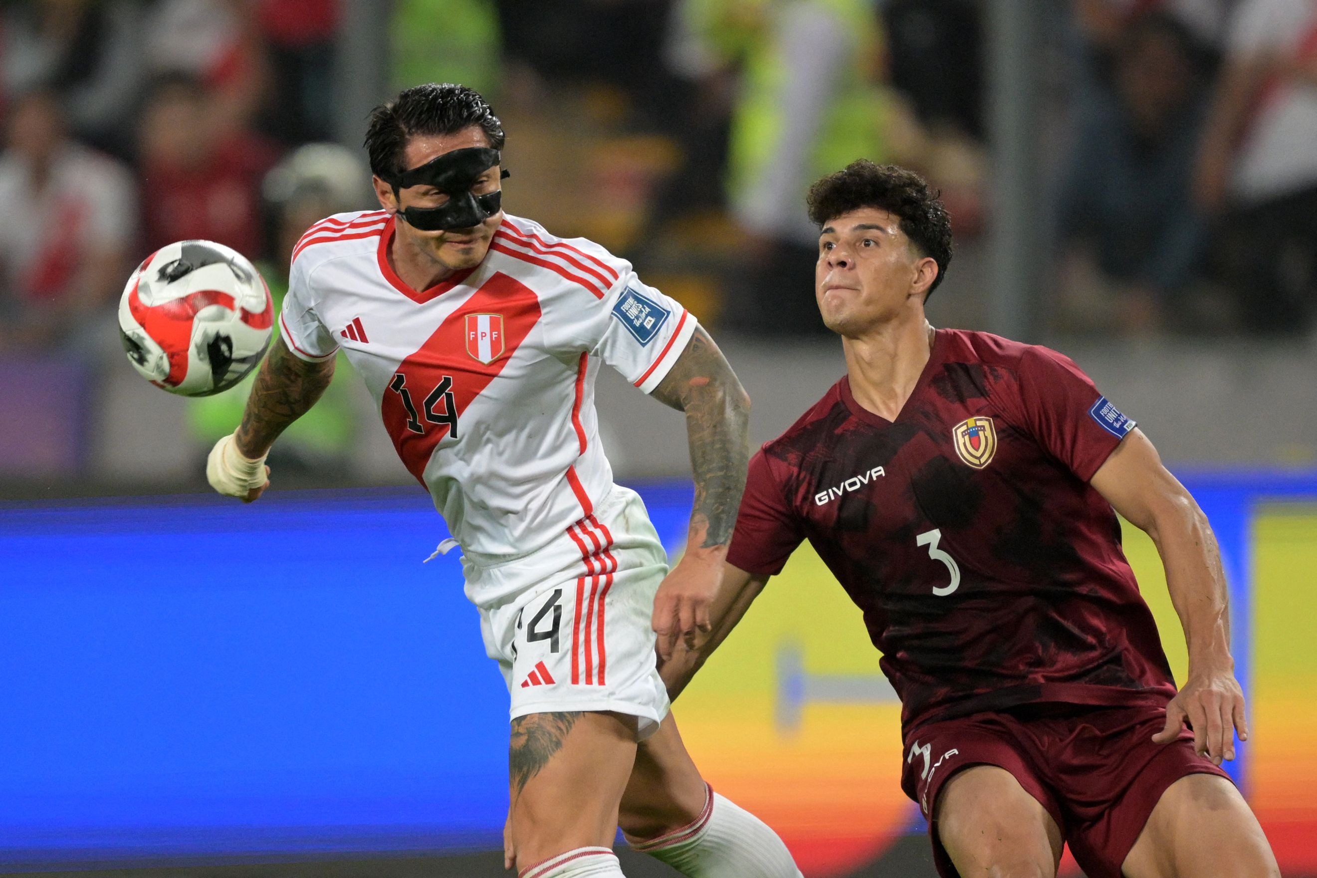 Peru's forward Gianluca Lapadula (L) fights for the ball with Venezuela's defender Yordan Osorio during the 2026 FIFA World Cup South American qualification football match between Peru and Venezuela at the National Stadium in Lima on November 21, 2023. (Photo by ERNESTO BENAVIDES / AFP)
