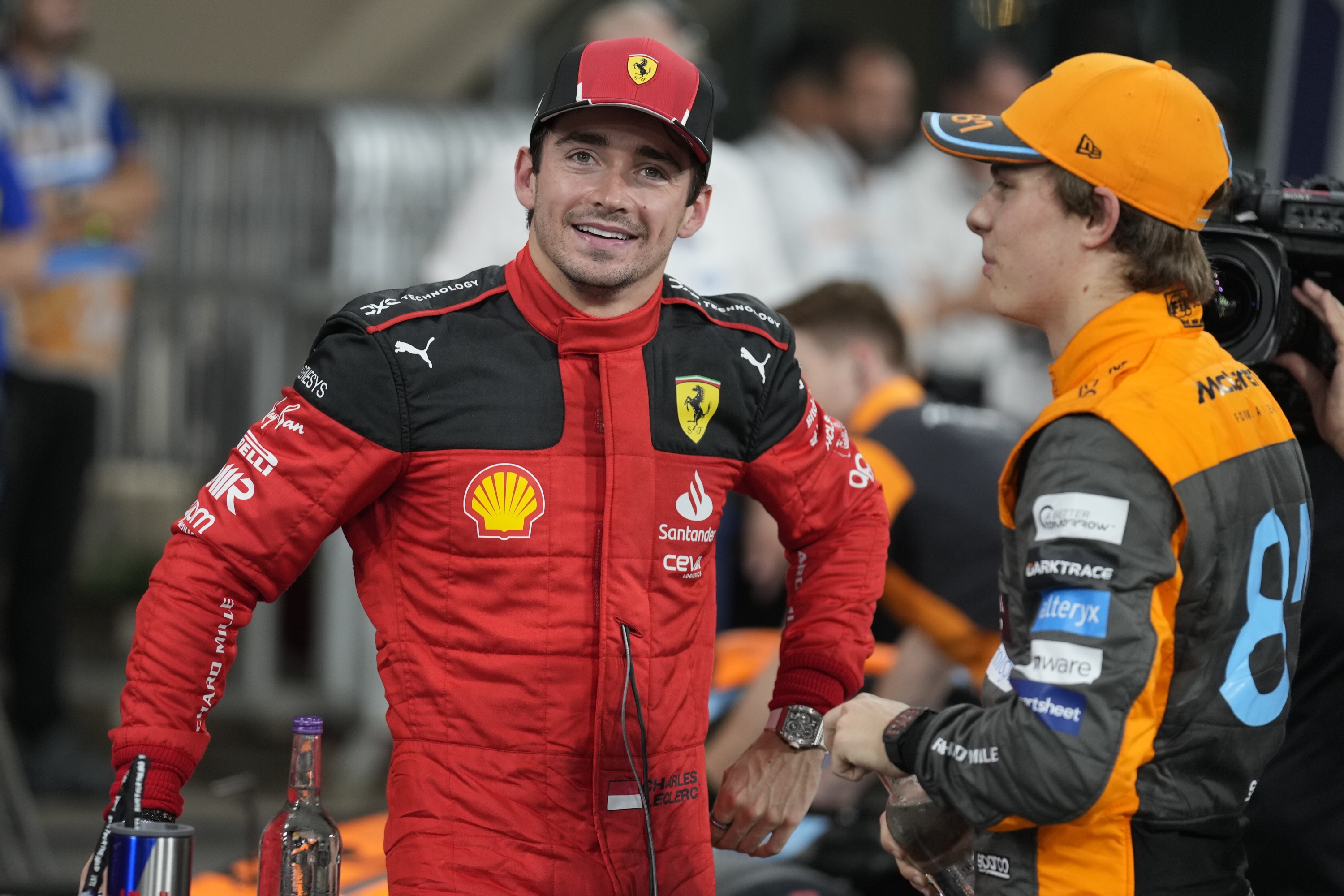 Ferrari driver Charles Leclerc of Monaco, left, chats with McLaren driver Oscar Piastri of Australia after qualifying session ahead of the Abu Dhabi Formula One Grand Prix at the Yas Marina Circuit, Abu Dhabi, UAE, Saturday, Nov. 25, 2023. (AP Photo/Kamran Jebreili)